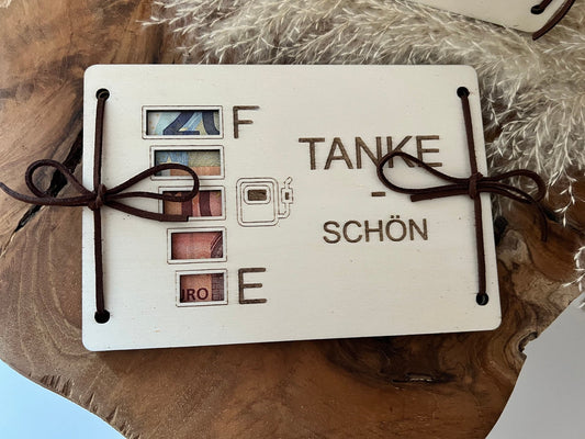 Geldgeschenk als Tankgutschein.
2 Gravierte Holzplatten für Tank-Geschenke. mit der Aufschrift Tanke-schön. Die Holzplatten werden zusammengelegt und miteinander verunden. Die Tankanzeige ist ausgeschnitten, wobei das Geld durchscheint.